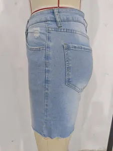 Side view of high waist distressed light blue denim shorts with raw hem