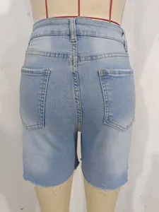 Rear view detail of women's high-waisted light blue denim biker shorts with raw hem