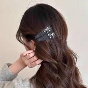 Chic grey fuzzy hair clips with sparkling rhinestone bows, perfect for styling side bangs and hair.