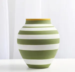 Detailed view of a Nordic minimalist hand-painted green and white striped ceramic vase