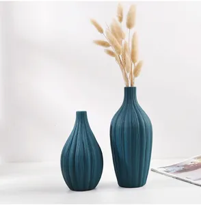 Juego de dos jarrones minimalistas de cerámica azul pavo real con textura decorativa