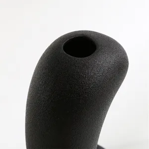 Detailed close-up showing the grainy matte texture of a modern black ceramic vase