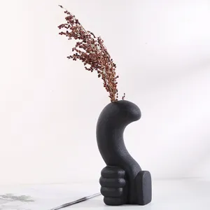 Modern minimalist black ceramic vase with unique thumb-up hand shape design