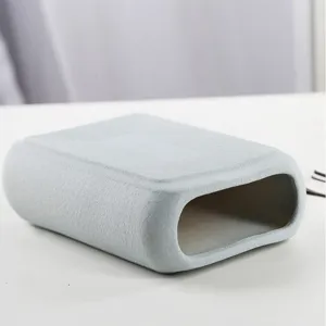 Close-up of minimalist matte light blue ceramic vase showing texture and opening