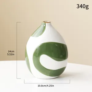 Artistic hand-painted ceramic vase with green swirls, dimensions 14x10.8cm, weight 340g