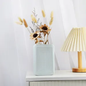 Minimalist Nordic style matte ceramic vase in mint blue with dried flower arrangement