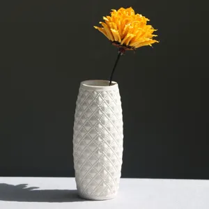 Modern white ceramic vase with diamond textured surface for minimalist home decor.