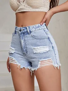 Detailed view of light blue high-waisted denim shorts with ripped holes and frayed hems.