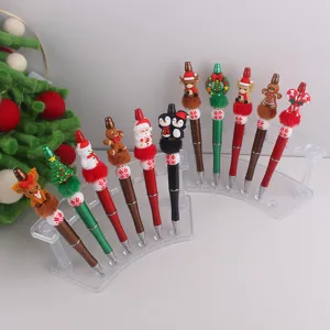 Detailansicht bunter Weihnachts-Gelschreiber mit süßen Silikonfiguren auf Acrylständern.