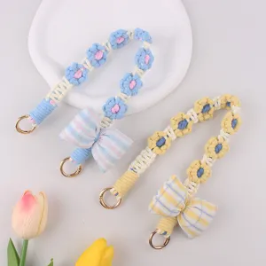 Handmade woven flower phone charm strap with cute plaid bow and metal ring for bags and keys.