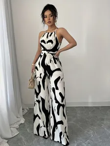 Chic black and white milk print halter wide-leg jumpsuit with waist-cinching design