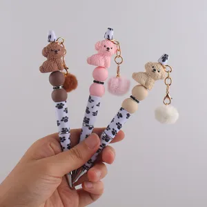 Detailansicht der niedlichen Hunde Silikon Perlen Gelschreiber mit Plüsch Pompon und Pfotenmuster.