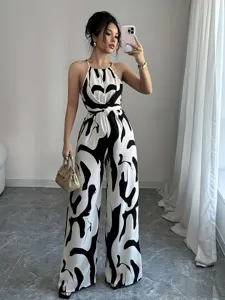 Chic black and white milk print halter neck jumpsuit with waist-slimming wide leg design