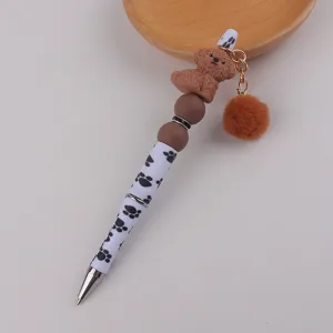 Süßer Perlengelstift mit flauschigem Bommelanhänger, brauner Pudelsilikonperle und Pfotenabdruck.