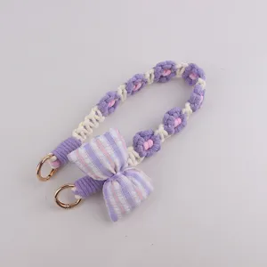 Handcrafted crochet flower phone strap with cute plaid bow and gold rings detail accessory