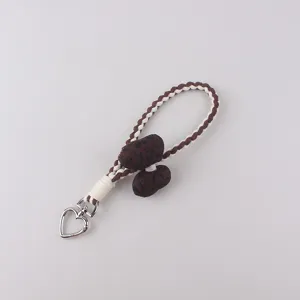 Detailed view of the cute leopard print braided keychain featuring a lovely silver heart clasp.