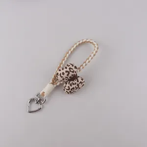 Cute leopard print braided phone lanyard keychain with heart clasp detail accessory.