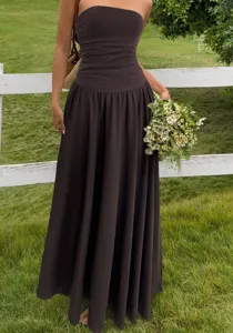 Detailed view of brown strapless maxi dress with ruched waist in garden setting