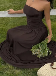 Detail view of a chocolate brown strapless maxi dress with elegant ruched waist and long skirt