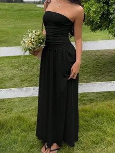 Elegant black strapless pleated maxi dress for summer beach vacation and chic resorts.
