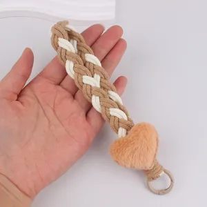 Plush heart braided keychain phone strap, cozy handmade woven bag charm for women.