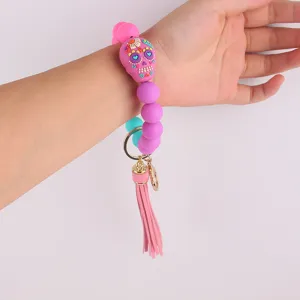 Silicone beaded wristlet keychain with sugar skull bead and leather tassel for women.