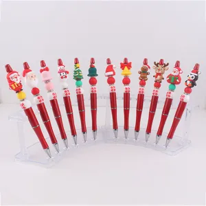 Weihnachtsperlen Stift Detailansicht zeigt verschiedene süße Silikon Cartoon Figuren auf Acryl.