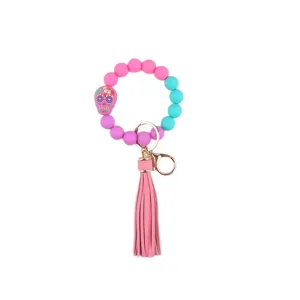Colorful silicone bead wristlet keychain with cute tassel and unique skull charm for women.