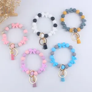 Portachiavi con Perline in Silicone con Fiocco Cartone Animato Bracciale ad Anello in Lega con Nappa Ciondolo Borsa Ornamento Moda per Donne Amici Regalo