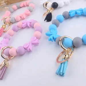 Portachiavi con braccialetto in perline di silicone colorate con fiocco e nappa accessori moda.
