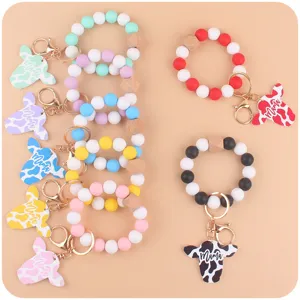 Colorful silicone bead wristlet keychain with cute cow head pendant and Mama script charm.