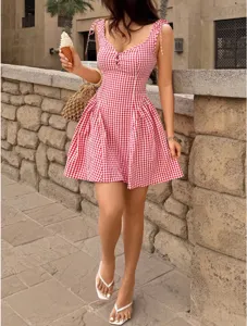Charming red and white gingham tie-shoulder mini dress featuring a flared summer skirt