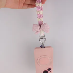Handmade woven phone lanyard charm with pink bow and heart metal clasp for daily smartphone decor.