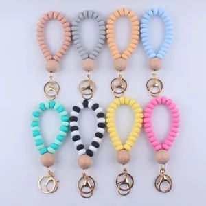 Silicone coiled wristlet keychain with wooden bead and metal clasp, multi-color detail.