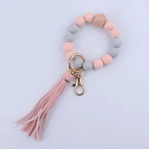 Llavero de pulsera de cuentas de silicona con borla de cuero y cuentas de madera
