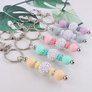 Silicone beaded keychains with sparkly rhinestone balls and metal rings for bags and keys.