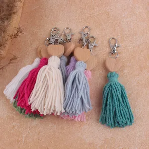 Bohemian beech wood heart cotton tassel keychain and bag charm detail view showing vibrant threads.