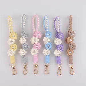 Handmade braided phone charm with cute pearl flowers and gold lobster clasps in sweet colors.