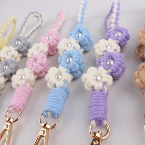 Detailed view of handmade crochet flower keychain with sweet candy colors and pearls.