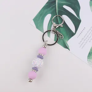 Silicone bead keychain with sparkly rhinestone charm for bags and keys, stylish accessory.