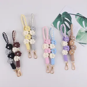 Handmade woven pearl flower keychain detail showing multiple candy colors and metal clasps