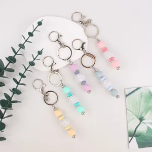 Colorful silicone beaded keychains with sparkly rhinestone balls and metal rings for bag charms.