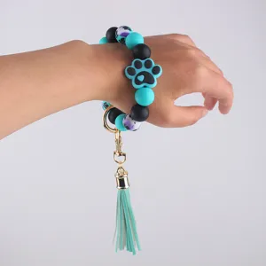 Silicone bead wristlet keychain with cute paw print and tassel pendant for women daily use.
