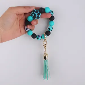 Silicone bead wristlet keychain with cute paw print charm and stylish leather tassel.