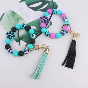 Silicone bead wristlet keychain with paw print charm and tassel for women daily use.