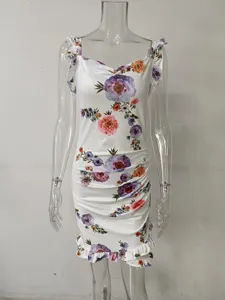 Close-up detail of a white sleeveless floral dress with ruffles and a V-neckline