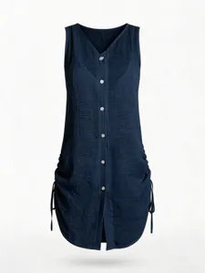 Detail of navy blue sleeveless button-down cotton dress with side drawstring feature.