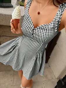 Close-up of a sweet black and white gingham sundress with square neck and slimming fit