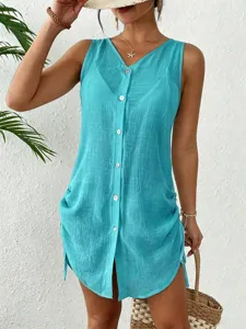 Close-up view of the button-down front and drawstring details on a turquoise cover-up