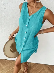 Close-up of a turquoise sleeveless cotton cover-up dress with side drawstring and buttons.